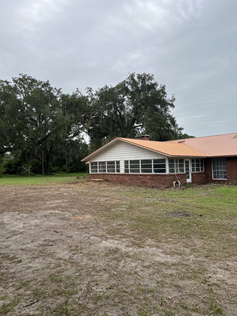 image of a house with a clean yard after the removal of a tree that was too close to the house