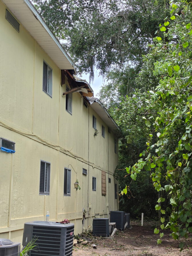 The tan house cleared and cleaned up after the fallen tree was removed